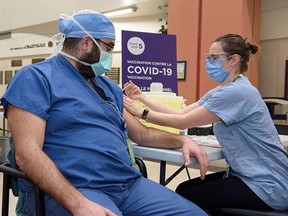 A COVID-19 vaccination is administered at the Jewish General Hospital.