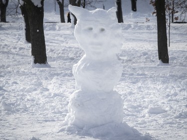 A unusual-looking snowman on path in Jeanne-Mance Park on Monday, Jan, 18, 2021 during the COVID-19 pandemic. People took advantage of the wet snow that fell over the weekend to go out and make snowmen all over town.
