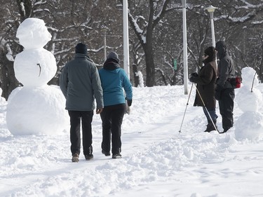 Snowmen line path in Jeanne-Mance Park on Monday, Jan. 18, 2021.