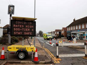 An ambulance passes a portable digital screen warning people of high COVID rates in Southend-On-Sea in eastern England, on January 1, 2021. A new variant of the SARS-CoV-2 virus discovered in Britain is considered relatively more infectious, though that does not mean it causes more serious disease, Joe Schwarcz says.