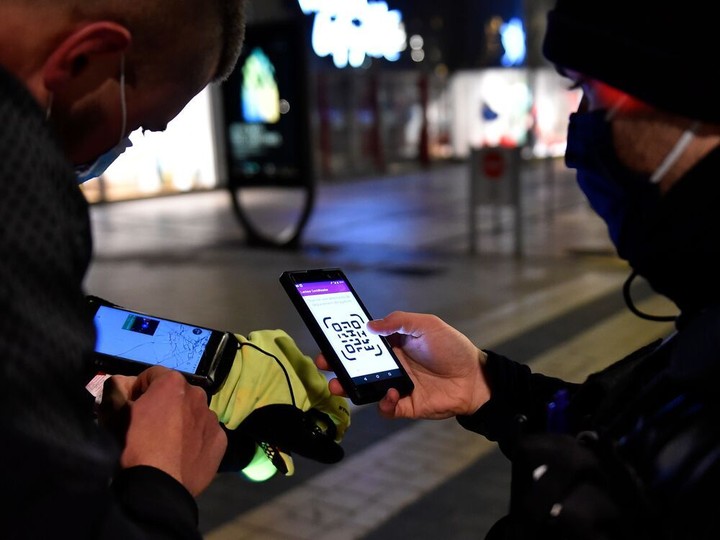  French policemen check the attestation of a man on January 5, 2021 in Metz, eastern France, as a new curfew is in effect in 15 French departments to fight against the spread of the new coronavirus.