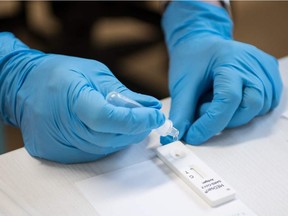 A nurse with protective gloves prepares a rapid antigen test for the coronavirus, on January 14, 2021 in Berlin.
