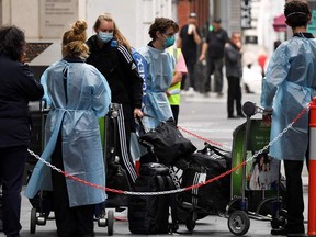 Tennis players, coaches and officials arrive at a hotel in Melbourne on Friday, Jan. 15, 2021, before quarantining for two weeks ahead of the Australian Open tennis tournament.