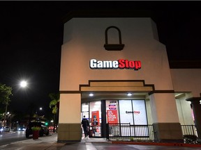 A man steps out of a GameStop store in Alhambra, California on January 27, 2021. - An epic battle is unfolding on Wall Street, with a cast of characters clashing over the fate of GameStop, a struggling chain of video game retail stores. Traders have been astounded in recent days by the surge in struggling video game retailer GameStop's share price, after a group of amateur investors banded together over the online platform Reddit to fight the Wall Street funds that had pushed its price lower.