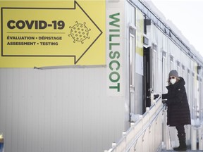 A woman wears a mask as she arrives to be tested for COVID-19 at a clinic in Montreal, Sunday, January 24, 2021.