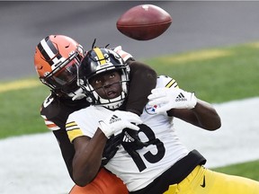 Cleveland Browns strong safety Ronnie Harrison (33) breaks up a pass intended for Pittsburgh Steelers wide receiver James Washington (13) during the second half at FirstEnergy Stadium in Cleveland on Sunday, Jan. 3, 2021.