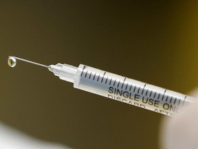 A syringe with a vaccine is seen ahead of trials by volunteers testing for the coronavirus disease (COVID-19), and taking part in the country's human clinical trial for potential vaccines at the Wits RHI Shandukani Research Centre in Johannesburg, South Africa, August 27, 2020. Picture taken August 27, 2020. REUTERS/Siphiwe Sibeko