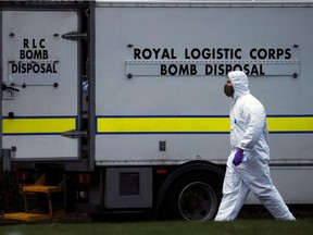 A police forensic officer walks past a bomb disposal unit van outside the Wockhardt pharmaceutical plant in Wrexham, Britain January 27, 2021. REUTERS/Phil Noble