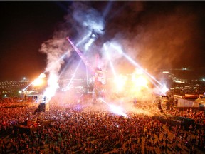 FILE PHOTO: Festival goers in the late night Arcadia area during Glastonbury Festival in Somerset, Britain June 28, 2019. Picture taken June 28, 2019. REUTERS/Henry Nicholls/File Photo