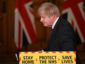 British Prime Minister Boris Johnson leaves after speaking at a coronavirus news conference at 10 Downing Street, London, Britain January 22, 2021. The prime minister announced that the new variant of SARS-CoV-2, which was first discovered in the south of England, appears to be linked with an increase in the mortality rate.