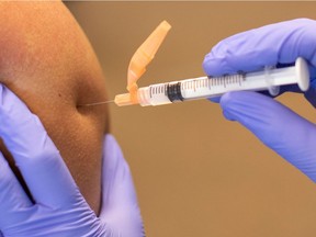 A CalFire firefighter is administered his first dose of the Moderna vaccine Jan. 15, 2021.