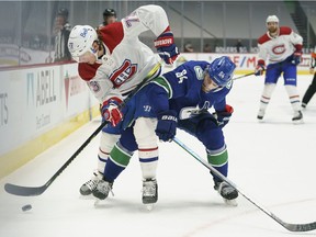 Canadiens' Tyler Toffoli battles Canucks' Tyler Motte for control of the puck during first period Thursday night in Vancouver.