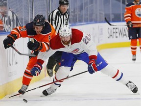 Canadiens defencemen Jeff Petry checks Oilers forward Kyle Turris at Rogers Place in Edmonton on Saturday, Jan. 16, 2021.