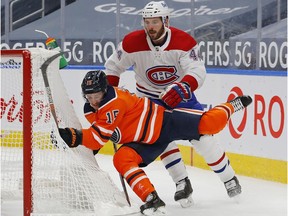 Canadiens defenecman Joel Edmundson (44) trips up Edmonton Oilers forward Josh Archibald (15) during the first period at Rogers Place on Saturday, Jan. 16, 2021.