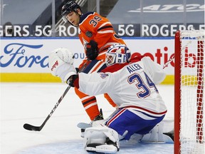 A shot deflects off Oilers forward Alex Chiasson in front of Canadiens goaltender Jake Allen during the third period at Rogers Place in Edmonton Monday night.