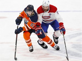 Montreal Canadiens defenceman Shea Weber and Edmonton Oilers forward Ryan Nugent-Hopkins chase a loose puck during the third period at Rogers Place in Edmonton on Jan. 18, 2021.