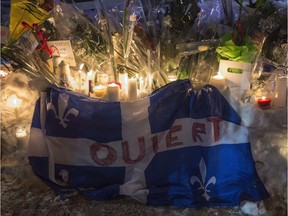 A Quebec flag bearing the word "ouvert" — "open" — is shown at a vigil following the Quebec City mosque massacre on Jan. 29, 2017.