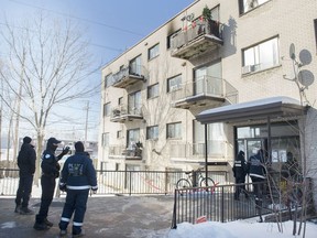 Police are shown outside an apartment building in Montreal, Sunday, January 31, 2021, where a woman lost her life in a fire.