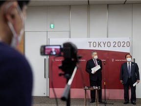 Tokyo Olympic and Paralympic Games Organizing Committee (TOGOC) pesident Yoshiro Mori and CEO Toshiro Muto speak to the media after a video conference with IOC president Thomas Bach at the TOGOC headquarters in Tokyo on Jan. 28, 2021.