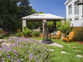 A flagstone path on the flat terrain next to the house leads to the gazebo on the raised patio deck from where Serge and Sylvie like to sit and admire their garden from.