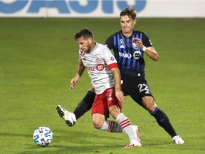 Sep 9, 2020; Montreal, Quebec, CAN; Toronto FC forward Pablo Piatti (7) and Montreal Impact defender Jukka Raitala (22) battle for the ball during the first half at Stade Saputo. Mandatory Credit: Jean-Yves Ahern-USA TODAY Sports