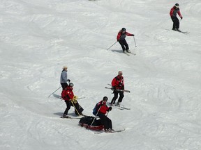 Ski patrollers transport an injured person at Mont Tremblant in 2009. A study of injury trends at western Canadian ski resorts across 10 seasons showed that falls were the most likely cause of injury, followed by collisions or near collisions.
