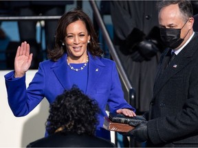 Kamala Harris is sworn in as Vice-President as her spouse, Doug Emhoff, holds a Bible during the 59th Presidential Inauguration at in Washington on Jan. 20, 2021.