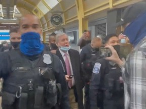 U.S. Senator Lindsey Graham is escorted by security personnel as Trump supporters berate him, at Reagan National Airport in Washington on Friday, Jan. 8, 2021, in this still image obtained from a social media video.