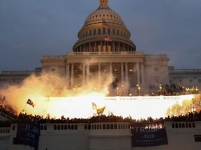 An explosion caused by a police munition is seen while supporters of U.S. President Donald Trump gather in front of the U.S. Capitol Building in Washington, U.S., January 6, 2021.