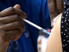 A nurse administers a COVID-19 vaccine.