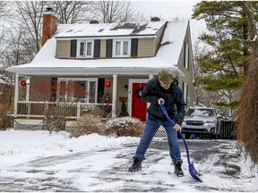 John Mayo shovels the driveway of his Pointe-Claire home. The appeal of more space has led many — families, especially — to leave the city in search of greener pastures this pandemic year.