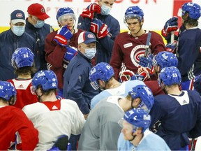 Montreal Canadiens head coach Claude Julien, centre, talks to players during training-camp practice at the Bell Sports Complex in Brossard on Jan. 6, 2021.