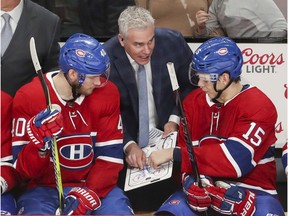 Montreal Canadiens assistant coach Dominique Ducharme talks strategy with Joel Armia, left, and Jesperi Kotkaniemi during third period against the Florida Panthers in Montreal on Jan. 15, 2019.