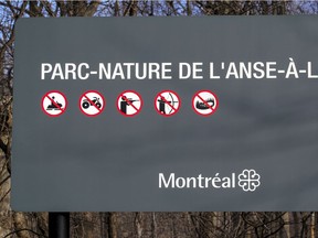 A sign at the entrance to L'Anse-à-l'Orme Nature Park in Kirkland shows that trapping and hunting are not permitted.