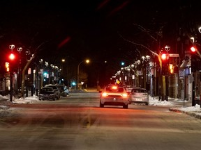 Montreal police patrol Wellington St. during the Quebec-wide curfew.