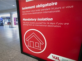 A sign at Montreal's Trudeau airport reminds travellers about quarantine regulations. Prime Minister Justin Trudeau says new rules will likely take effect in mid-February.