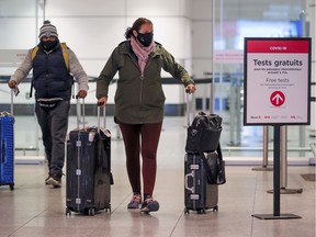 Passengers arrive at Montréal–Trudeau International Airport on flight from the United States Jan. 26, 2021.