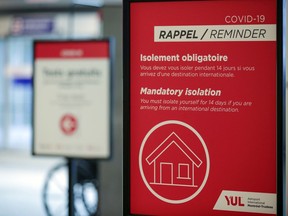 MONTREAL, QUE.: JANUARY 26, 2021 -- Sign reminding travellers about quarantine regulations in the arrivals area at Montréal–Trudeau International Airport Tuesday January 26, 2021. (John Mahoney / MONTREAL GAZETTE) ORG XMIT: 65664 - 6760