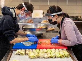 Zera Café employee Daniel Lach, left, works with job coach Caroline Mosel, preparing cabbage rolls. "This is great job training," Mosel says.