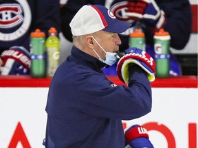 Head coach Claude Julien blows a whistle over his mask during Montreal Canadiens practice at the Bell Sports Complex in Brossard on Jan. 27, 2021.