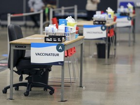 Three vaccination tables wait patients during media tour of new mass vaccination clinic at the Palais des Congrès in Montreal Monday February 1, 2021. But Montrealers still can't make appointments to be vaccinated here.