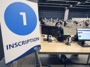 Registration desk at the new mass vaccination clinic run by the CIUSSS Centre-Sud at the Palais des Congrès in Montreal is seen on Monday February 1, 2021.