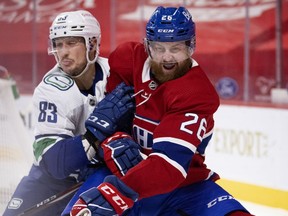 Canadiens defenceman Jeff Petry and Vancouver Canucks forward Jay Beagle battle position during game Monday night at the Bell Centre.