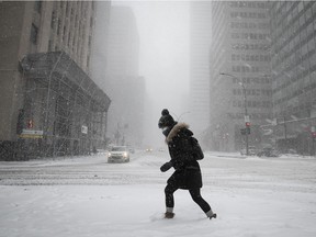 Emilie crosses Rene Levesque at Beaver Hall under the falling snow of a winter storm on Feb. 2, 2021