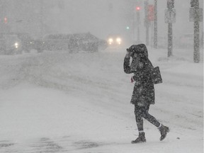 A pedestrian crosses René Lévesque Blvd. in downtown Montreal on Tuesday February 2, 2021. We're all weathering the storm in our own ways, but it's not easy, Fariha Naqvi-Mohamed says.