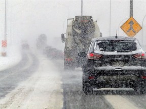 Visibility was limited on Highway 20 through the St-Pierre Interchange during a snowstorm in Montreal on Feb. 2, 2021.