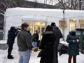 People from native and Innu communities gather at the opening of a new warming shelter, inside a 40-by-25-foot tent in Cabot Square, in Montreal, on Wednesday, Feb. 3, 2021.