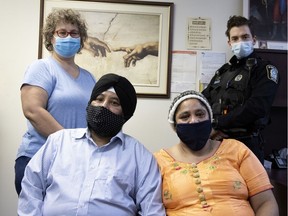 Gurmit Singh and Santokh Kaur took in an injured police officer. Now members of the SPVM, headed by Manon Trepanier, retire constable, and Francis Vigneault of Station 22 are trying to raise funds to help the recently arrived immigrants from India get established in Montreal. They are seen in Montreal, on Friday, Feb. 5, 2021.