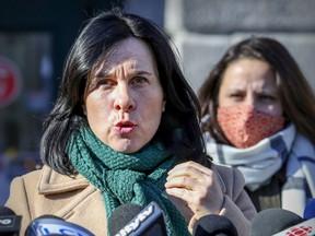 Caroline Bourgeois, right, executive committe member responsible for public security, listens as Montreal Mayor Valérie Plante comments on the Quebec office of criminal prosecution's decision Wednesday to stay charges against Mamadi Fara Camara, who had been accused, and held for almost a week, in what Montreal Police had said was an attempt to murder a police officer, during press conference outside City Hall in Montreal Thursday, Feb. 4, 2021.
