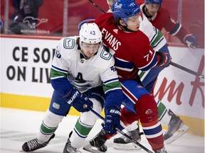 Canadiens' Jake Evans gets squeezed between Canucks defenceman Quinn Hughes, front,  and Brandon Sutter during action at the Bell Centre Tuesday night. Evans was drafted in the seventh round in 2014 by Montreal.